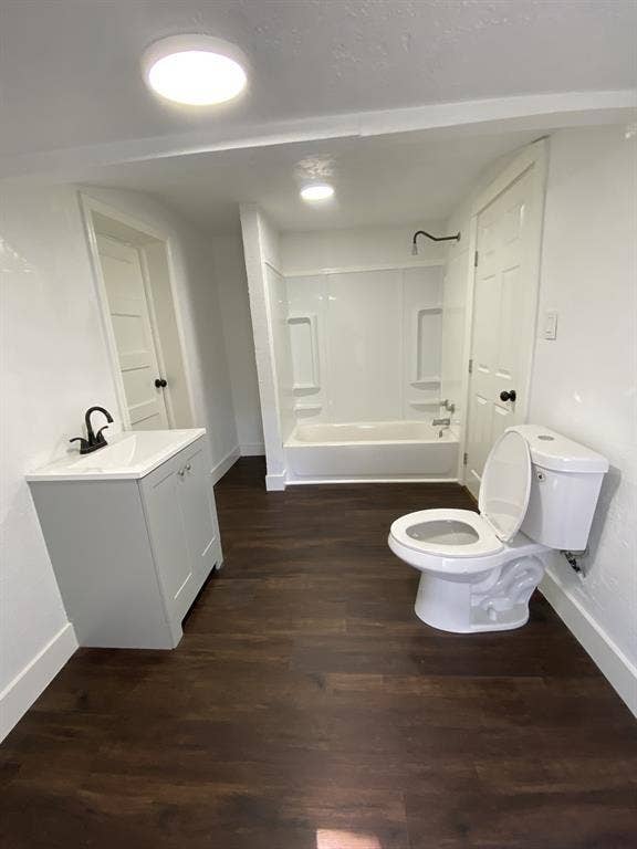 801 Walnut Street, Trinidad, TX 75163 Wood-finish flooring, white walls, and a contemporary vanity with a black faucet