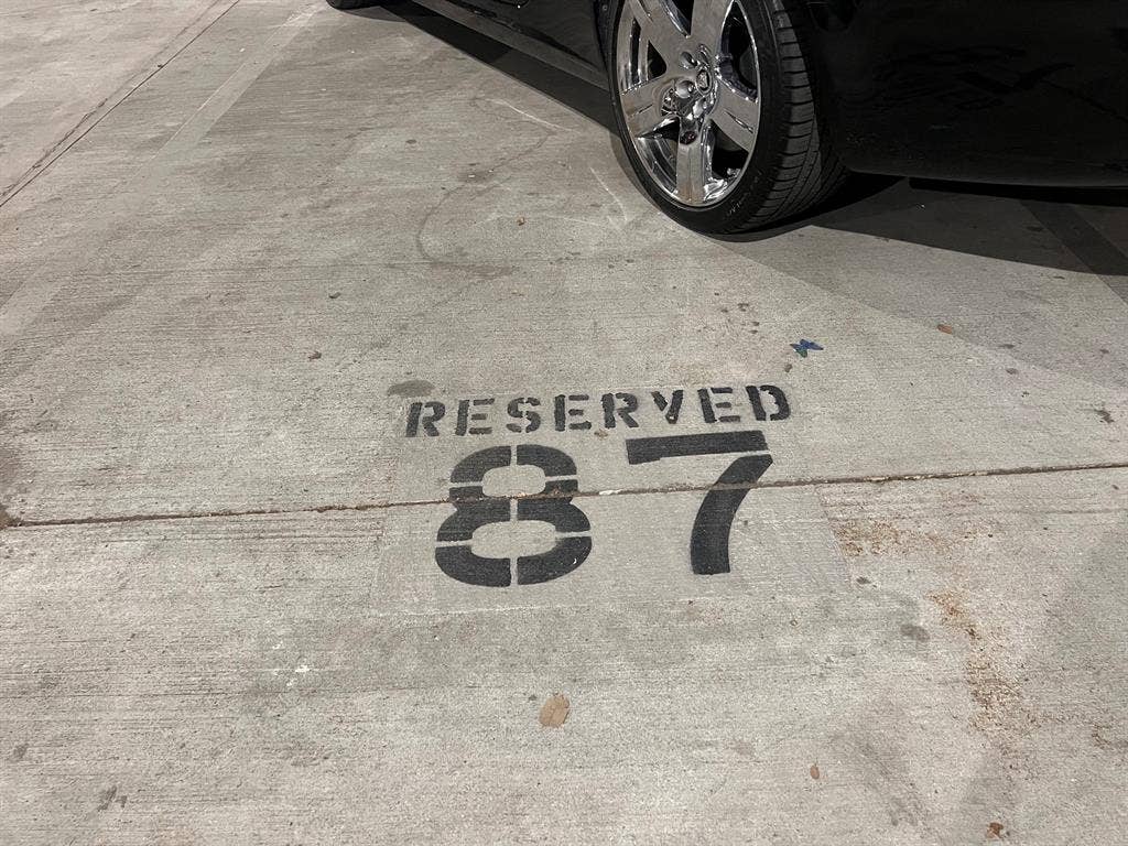 2305 Worthington Street, #104, Dallas, TX 75204 End parking spot in the gated garage parking and side-by-side assigned spots.