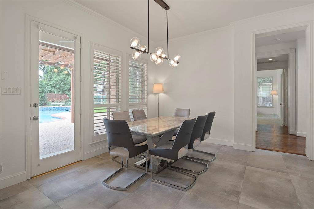 Tile flooring, white plantation shutters, glass-paneled door, modern chandelier