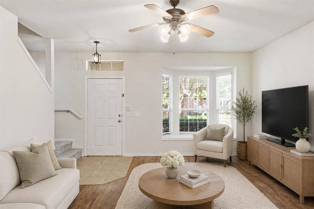 7449 Danbridge Lane, Frisco, TX 75035 Virtually staged living room highlighting the home’s bright, inviting layout and bay window.