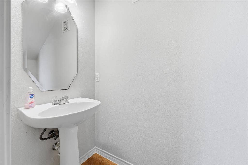 7449 Danbridge Lane, Frisco, TX 75035 Convenient downstairs half bath for residents and guests.