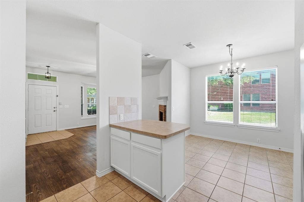 7449 Danbridge Lane, Frisco, TX 75035 Unstaged view of the open kitchen and breakfast area with great natural light and an easy flow into the living space.
