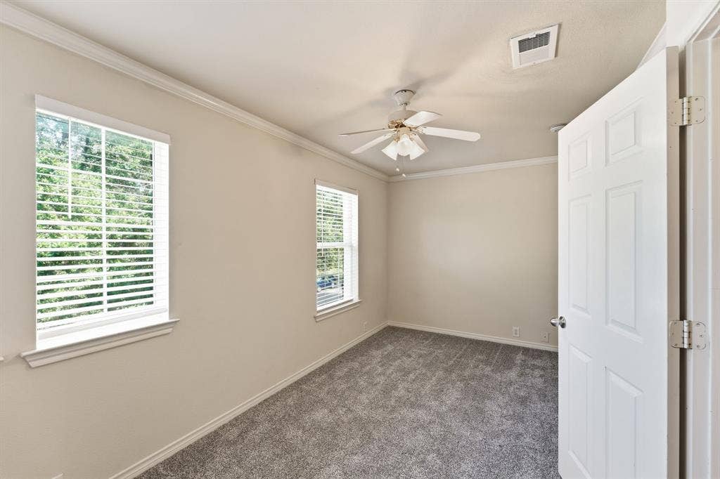 7449 Danbridge Lane, Frisco, TX 75035 Comfortable second bedroom featuring fresh paint, new carpet, and abundant natural light.