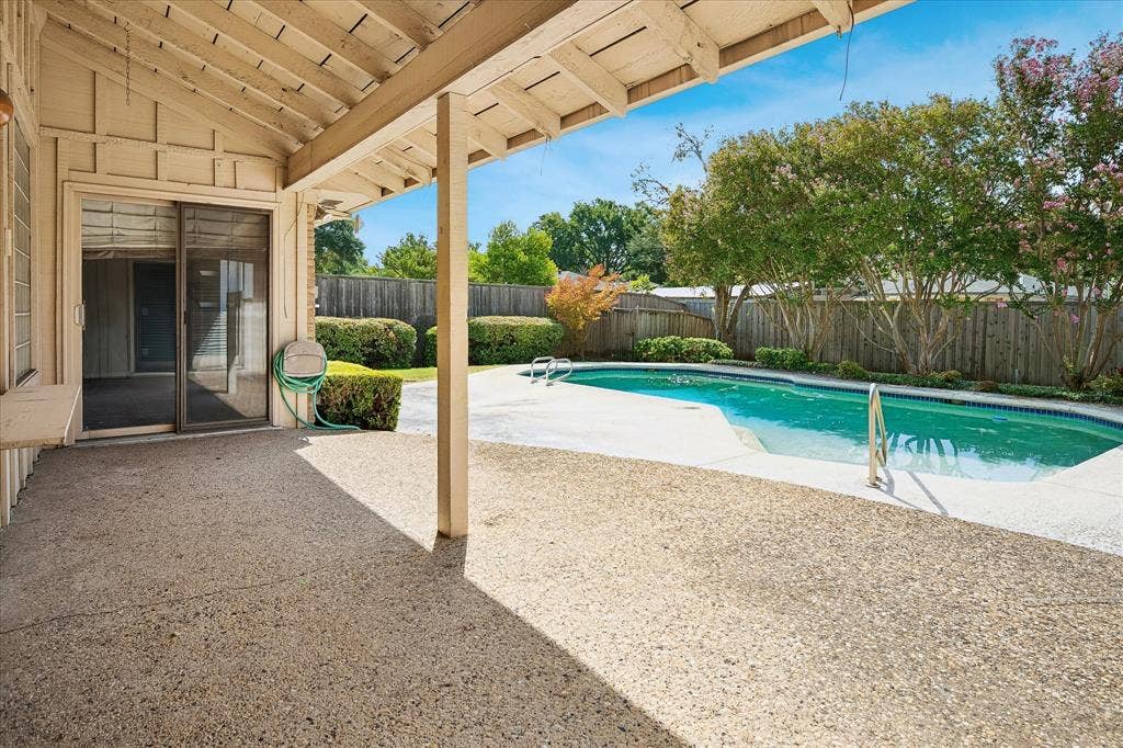 4108 Myerwood Lane, Dallas, TX 75244 Covered patio overlooking a private, fenced backyard pool surrounded by mature landscaping