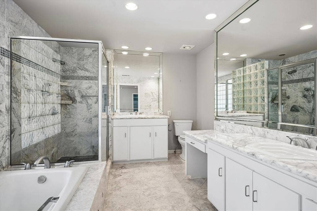 4108 Myerwood Lane, Dallas, TX 75244 Luxurious marble primary bath with a soaking tub, walk-in glass shower, and dual vanities.