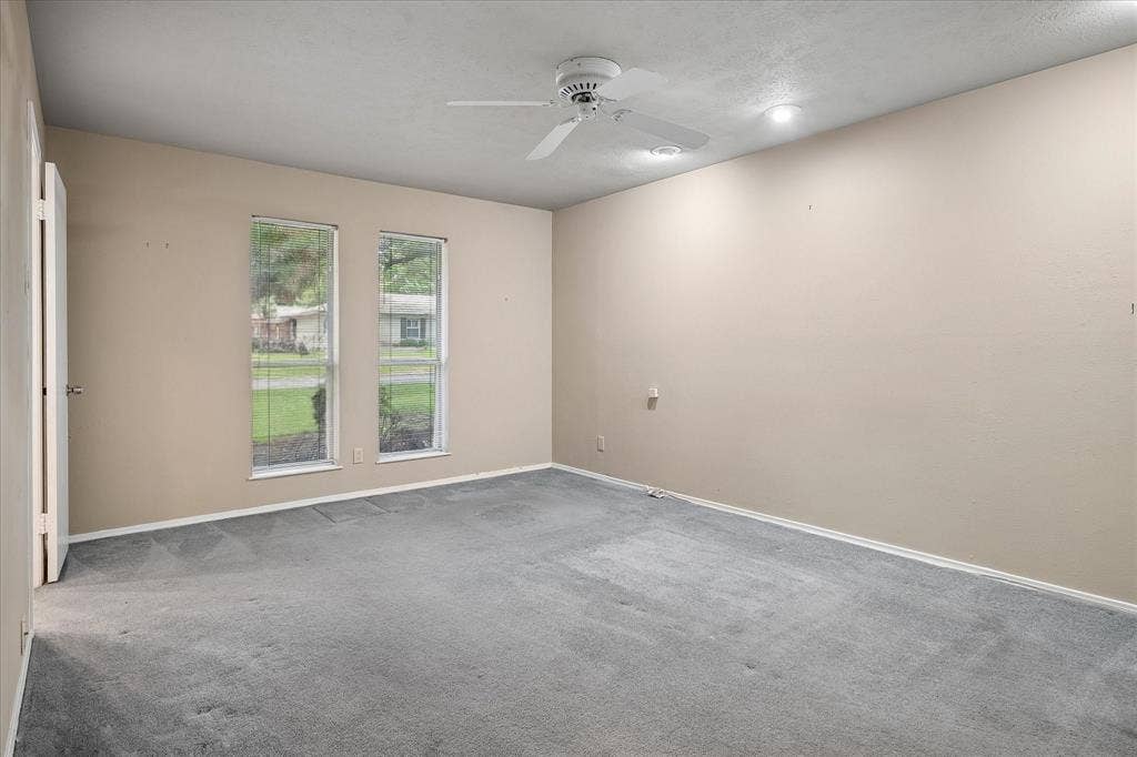 4108 Myerwood Lane, Dallas, TX 75244 Bedroom with tree-lined window views and access to a shared Jack-and-Jill bathroom.
