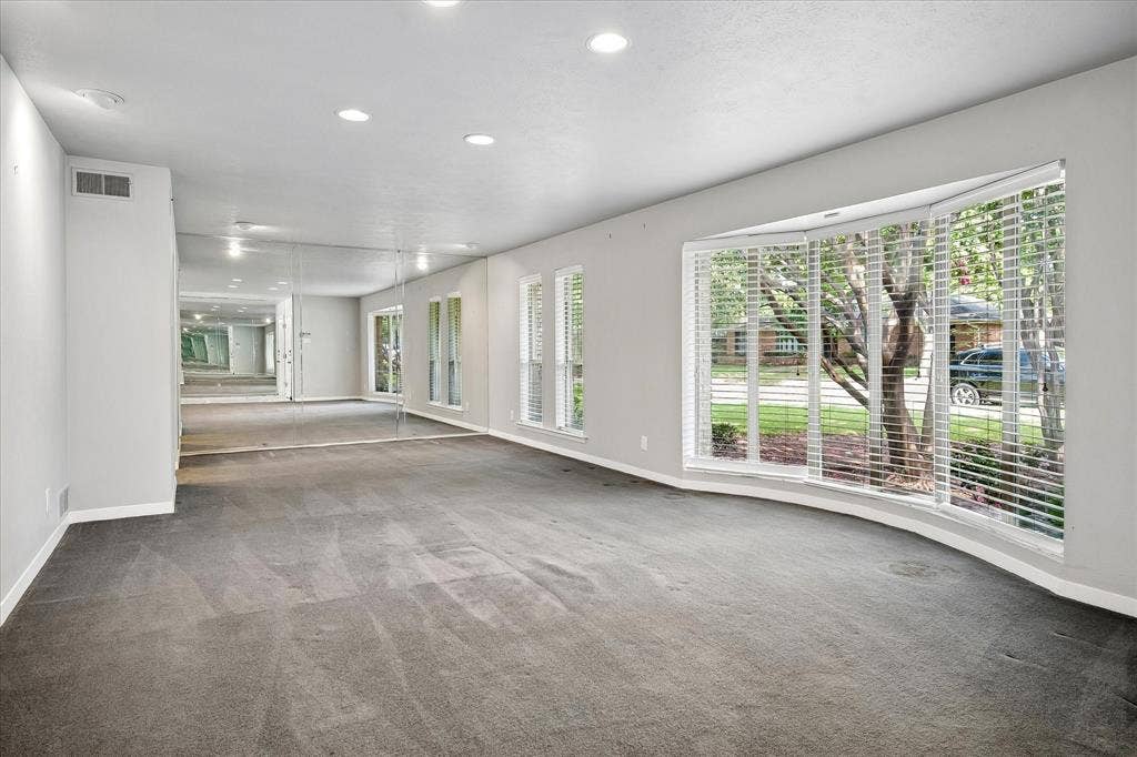 4108 Myerwood Lane, Dallas, TX 75244 Spacious formal living area with curved bay window that floods the room with natural light.