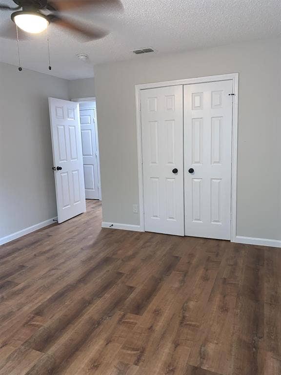 120 Plumthicket Lane, Trinidad, TX 75163 Wood-finish flooring, white paneled doors with black hardware, and a ceiling fan with integrated lighting