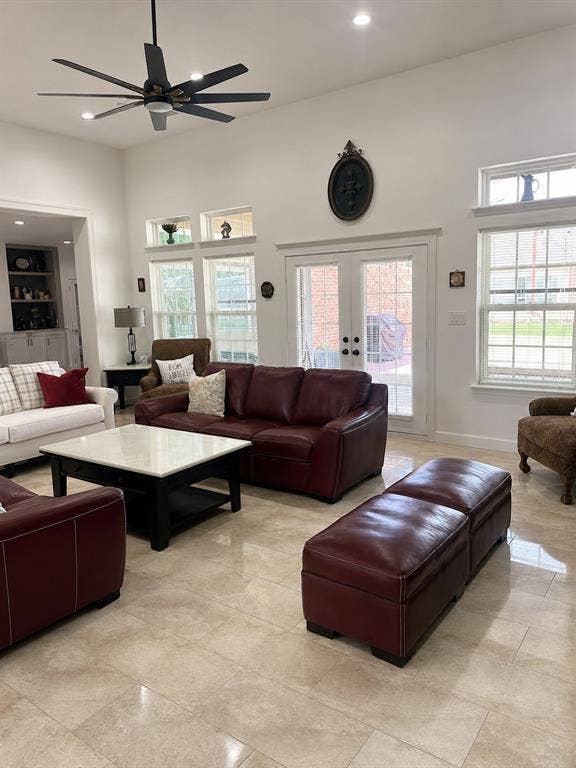 703 E Oates Road, Garland, TX 75043 Spacious living area featuring high ceilings, recessed lighting, a ceiling fan, light-toned tile flooring, and glass-paned French doors