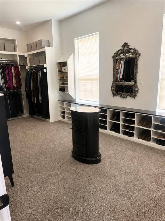 703 E Oates Road, Garland, TX 75043 Built-in custom closet system with extensive hanging rods, open shelving, and integrated shoe storage