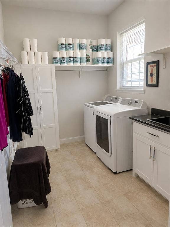 703 E Oates Road, Garland, TX 75043 Functional laundry room featuring a built-in white cabinet, overhead shelving, and a window with blinds