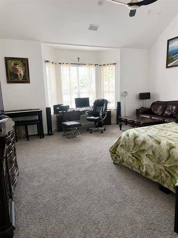 703 E Oates Road, Garland, TX 75043 Vaulted ceiling, ceiling fan, bay window, light gray carpet, and white walls