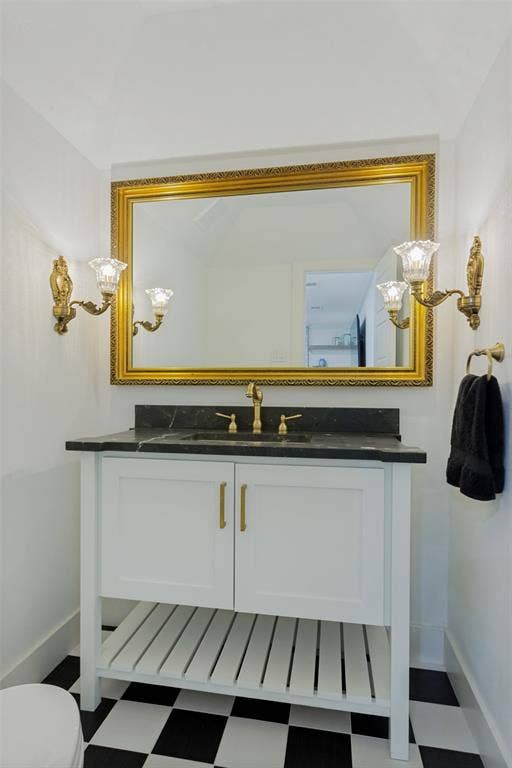 4316 Springbranch Drive, Benbrook, TX 76116 White vanity with gold-tone pulls, a dark countertop, and an undermount sink