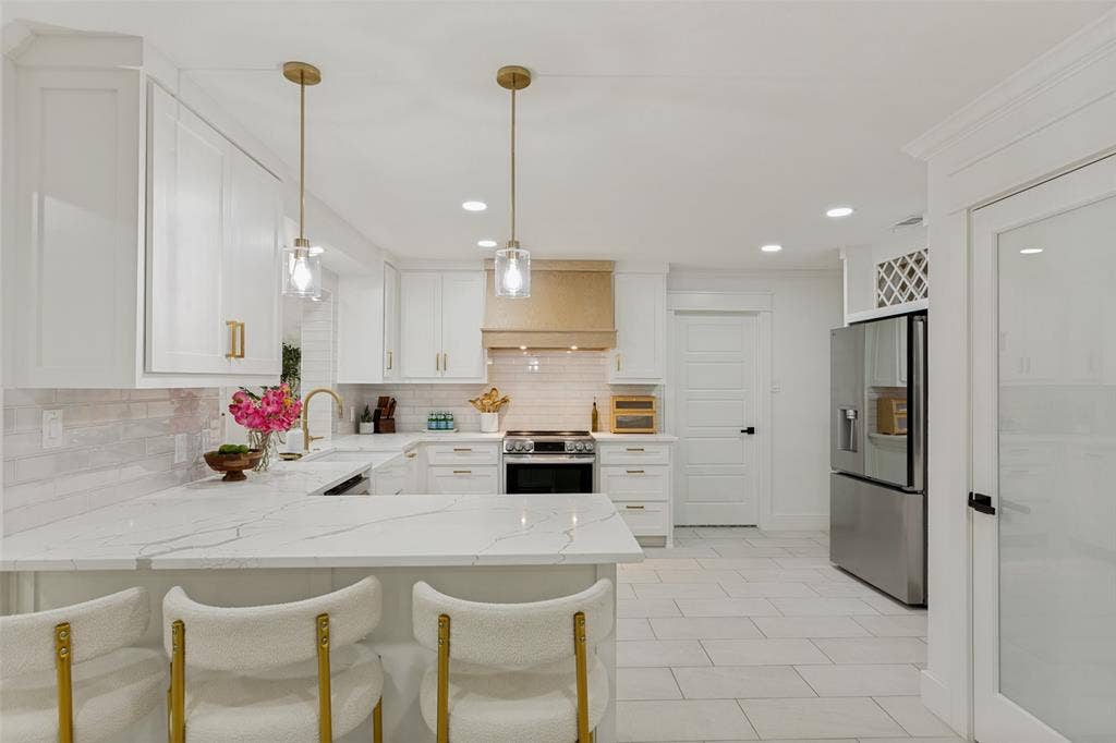 4316 Springbranch Drive, Benbrook, TX 76116 White shaker cabinetry, light-toned tile flooring, stainless steel appliances, marble-look countertops, and recessed lighting