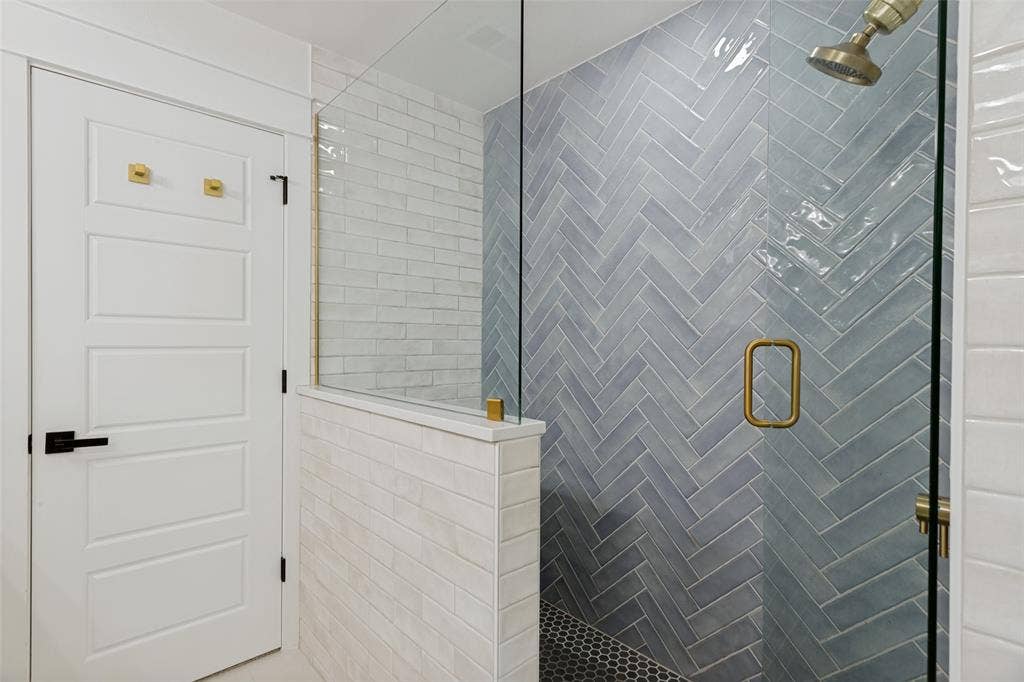 4316 Springbranch Drive, Benbrook, TX 76116 Frameless glass shower enclosure with a herringbone tile accent wall