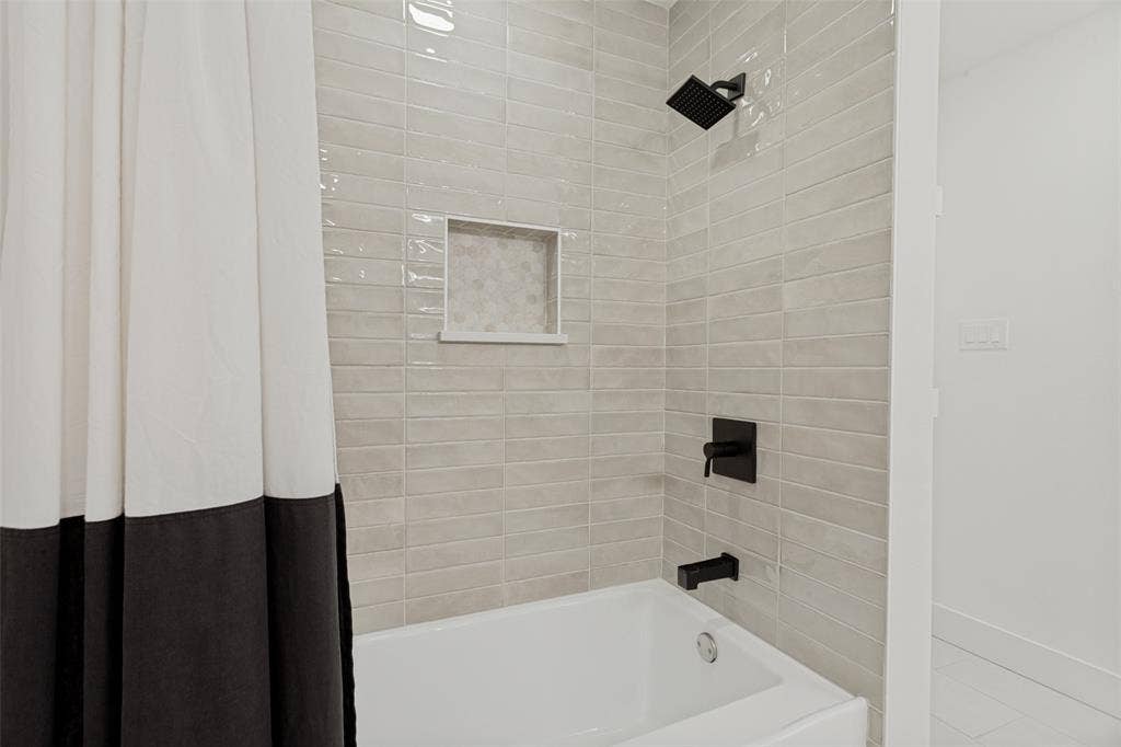 4316 Springbranch Drive, Benbrook, TX 76116 Subway tile shower surround with matte black fixtures and a recessed niche