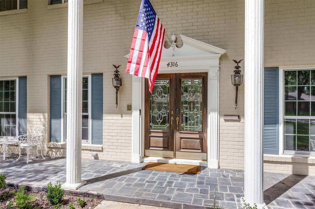 4316 Springbranch Drive, Benbrook, TX 76116 Cream brick exterior with decorative columns, a slate tile porch, and a double entry door with ornate glass inserts
