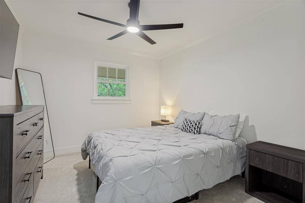 4316 Springbranch Drive, Benbrook, TX 76116 Recessed window with white trim, crown molding, and a modern ceiling fan with integrated lighting
