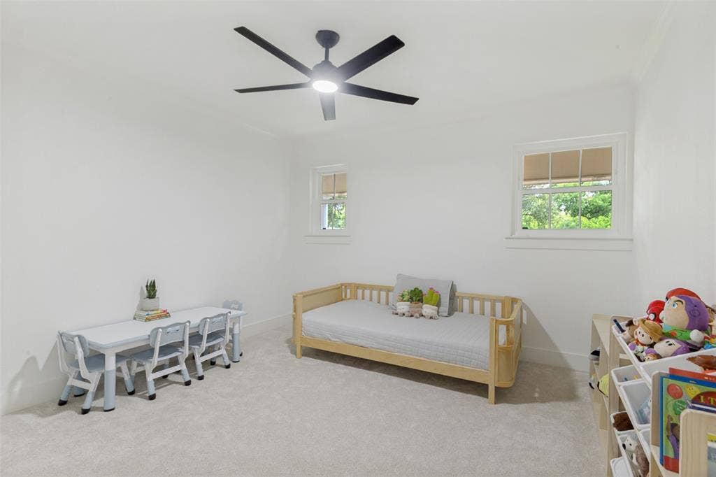 4316 Springbranch Drive, Benbrook, TX 76116 Recessed lighting and a ceiling fan fixture illuminate a room featuring two windows with white trim, and light-colored carpeting