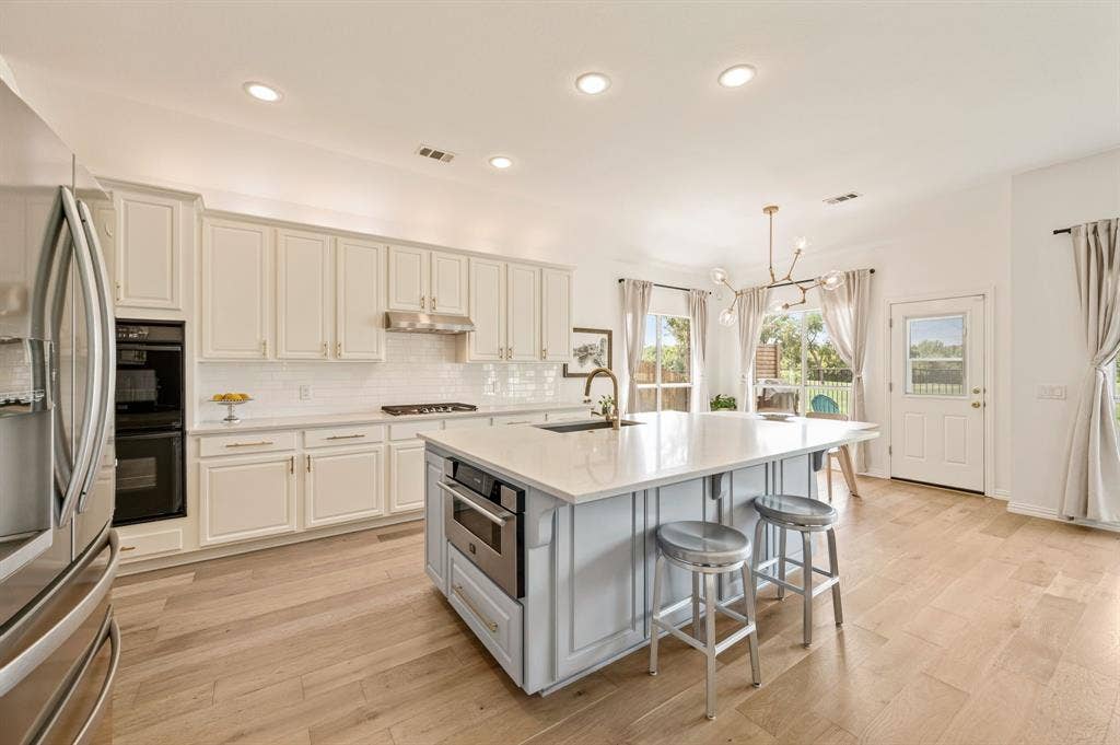 2404 Watercrest Drive, Keller, TX 76248 This kitchen is dreamy! Also, notice the upscale microwave drawer tucked into the oversized island.