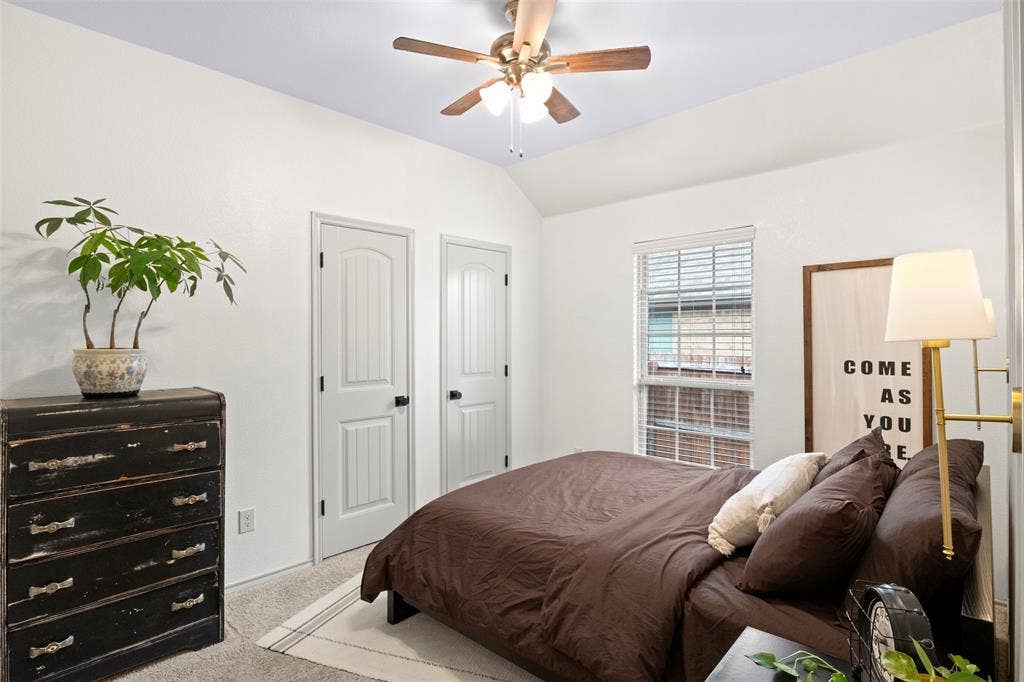 2189 Liriope Lane, Waxahachie, TX 75165 Secondary bedroom with a vaulted ceiling, neutral finishes, natural light and closet storage.