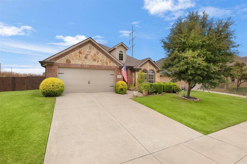 2189 Liriope Lane, Waxahachie, TX 75165 Brick and stone exterior, established landscaping and a mature shade tree give 2189 Liriope Ln a welcoming, established feel from the moment you arrive