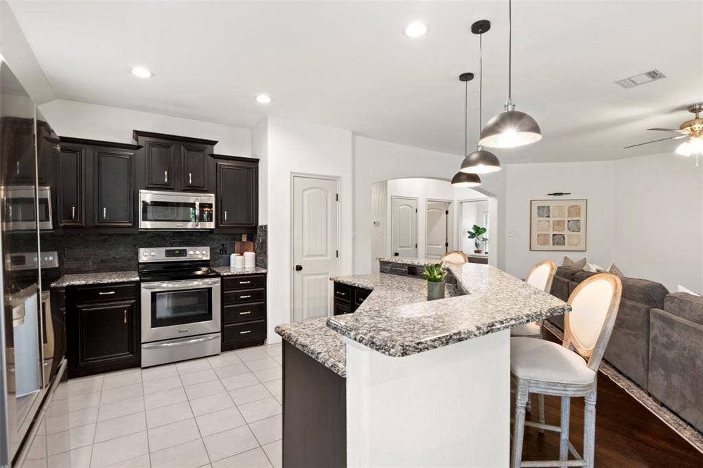 2189 Liriope Lane, Waxahachie, TX 75165 The extended breakfast bar provides seating for three while keeping the kitchen open to the main living area—ideal for everyday meals and entertaining.