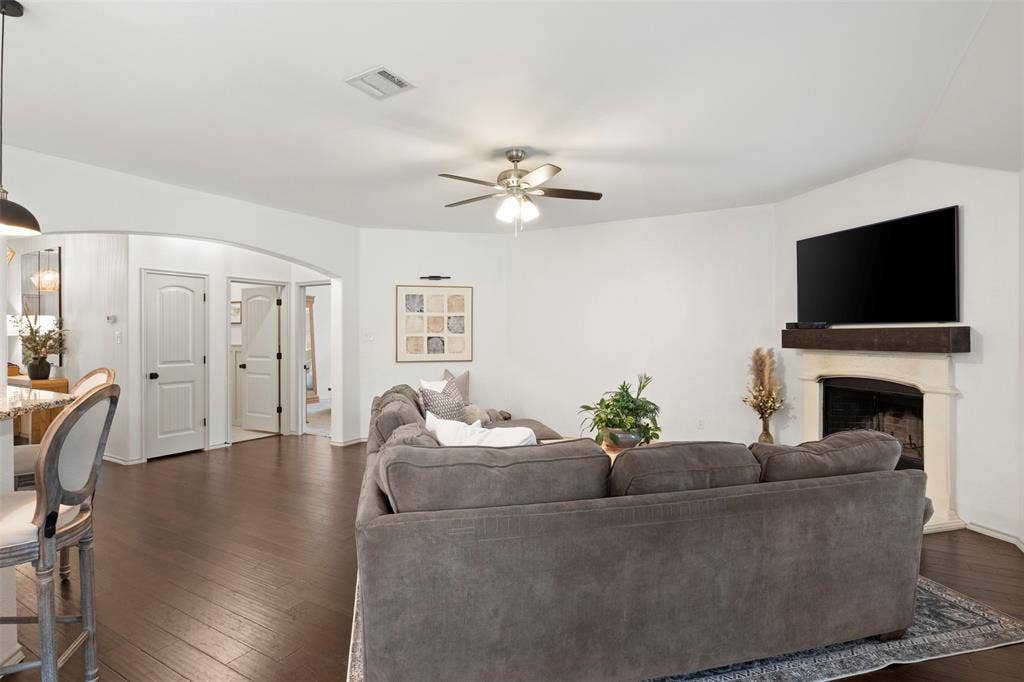 2189 Liriope Lane, Waxahachie, TX 75165 The wood-burning fireplace, generous seating area and backyard-facing windows create an inviting main living space