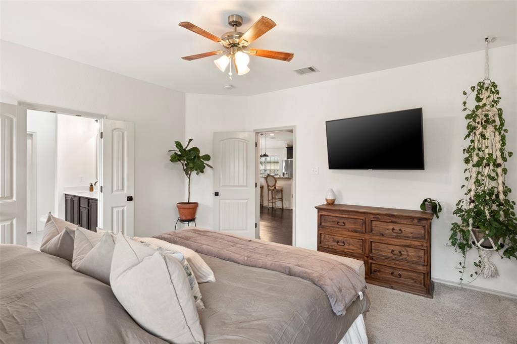 2189 Liriope Lane, Waxahachie, TX 75165 A second angle highlights the generous proportions of the primary bedroom, with plenty of room for substantial bedroom furniture without feeling crowded.