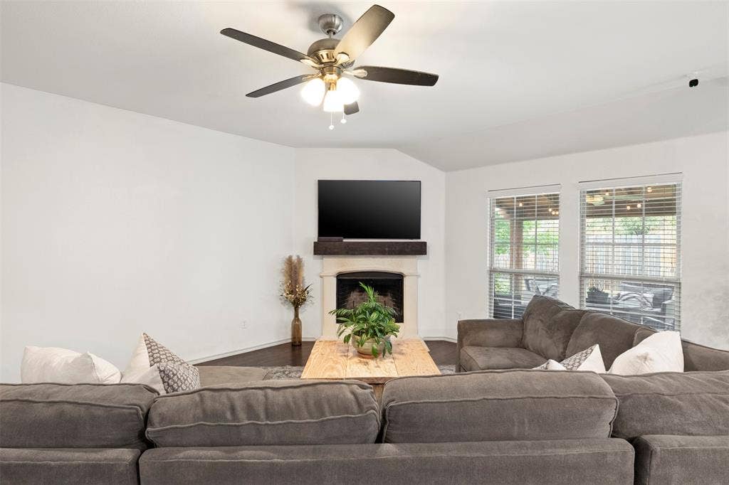2189 Liriope Lane, Waxahachie, TX 75165 The generously sized living area gives buyers plenty of room to gather, with dark flooring, fresh neutral paint and a WOOD-BURNING FIREPLACE anchoring the space.