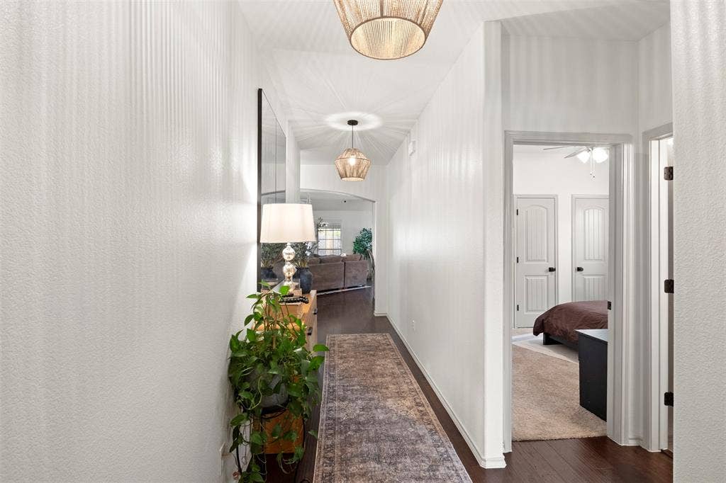 2189 Liriope Lane, Waxahachie, TX 75165 UPDATED FROM THE MOMENT YOU WALK IN. Fresh paint, updated lighting and dark flooring create a clean, current first impression, with the hallway opening directly into the home's main living spaces.
