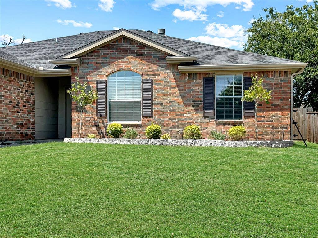 3457 Newgate Street, Midlothian, TX 76065 Recently installed shrubs highlight the front of the home