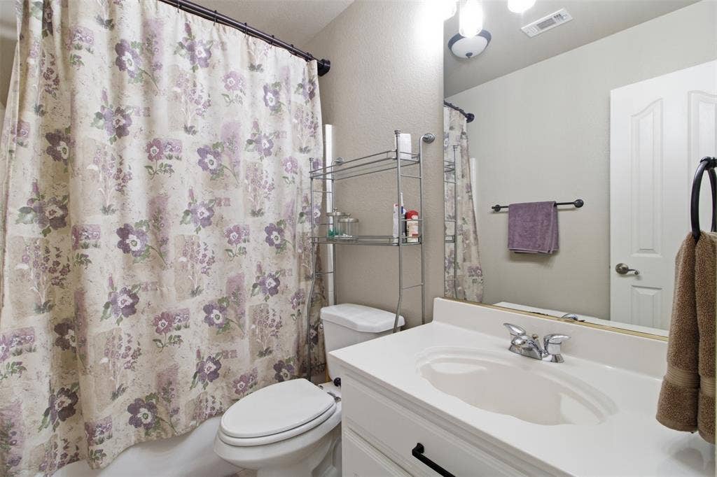 1112 Badbury Lane, Grand Prairie, TX 75052 White vanity with an integrated sink and chrome faucet
