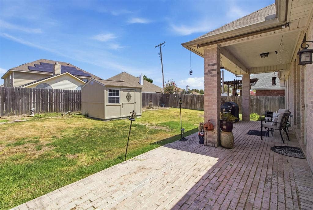 1112 Badbury Lane, Grand Prairie, TX 75052 Covered patio with brick columns and exterior lighting