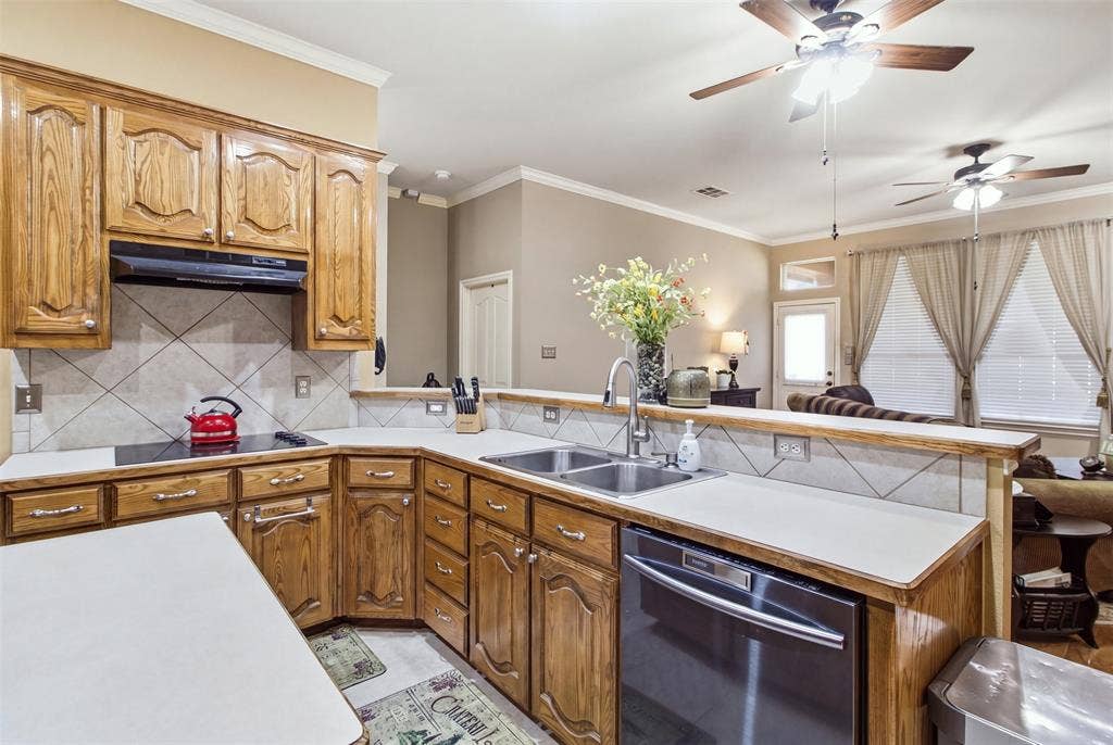 1112 Badbury Lane, Grand Prairie, TX 75052 Kitchen featuring wood cabinetry, white countertops, a tile backsplash, and stainless steel appliances