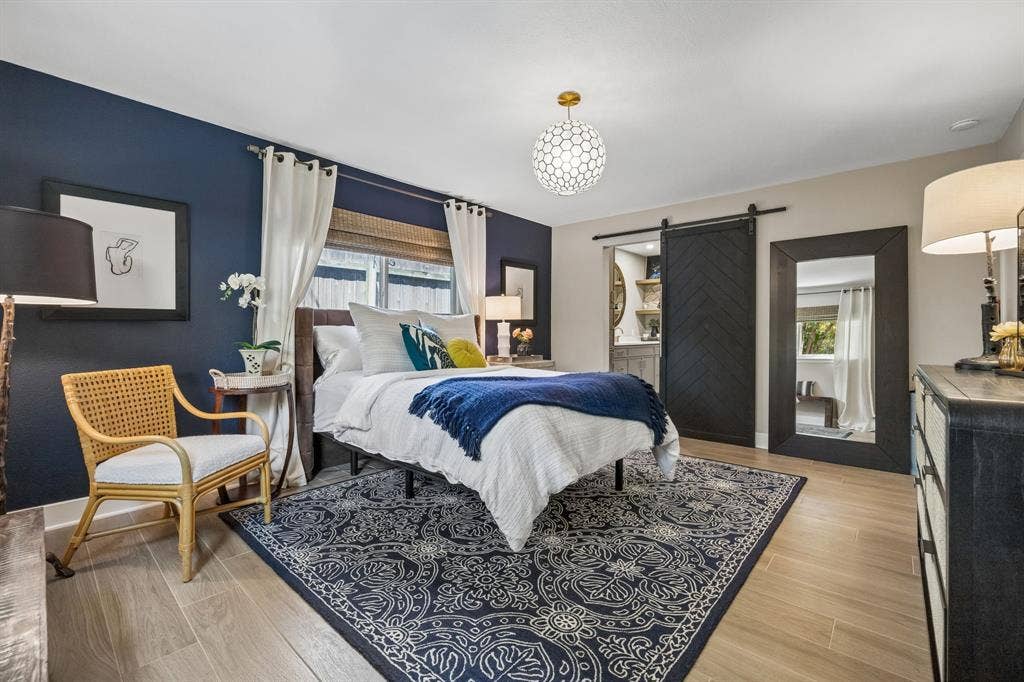 Wood-finish tile flooring with a decorative area rug