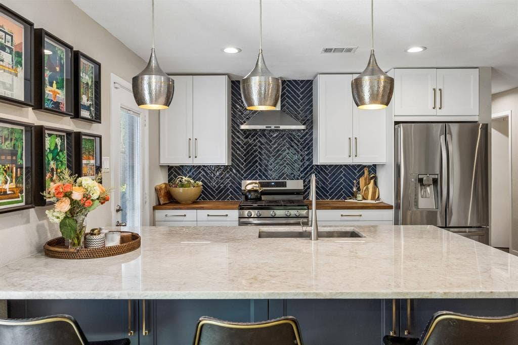 Spacious kitchen island featuring quartzite countertops