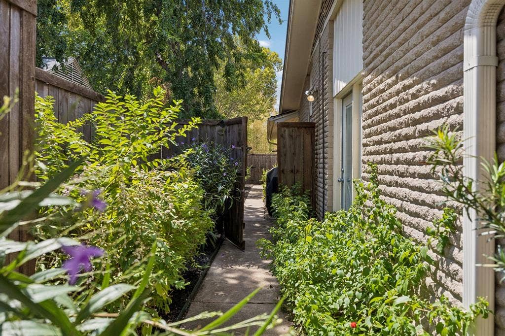 Beautifully landscaped walkway to the large backyard