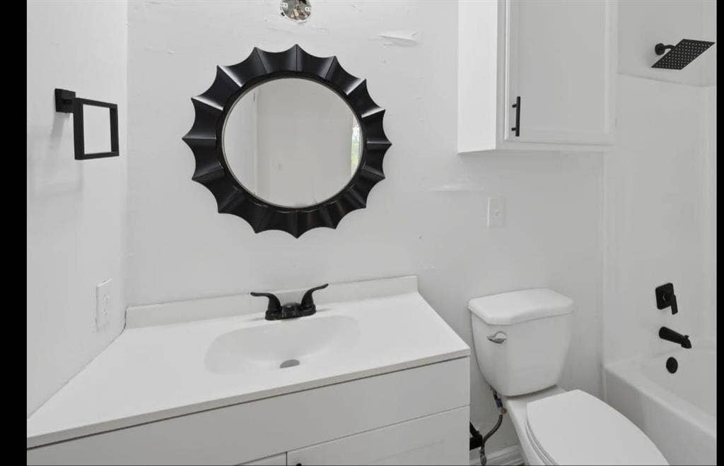 Vanity with integrated sink, matte black faucet, and white countertop