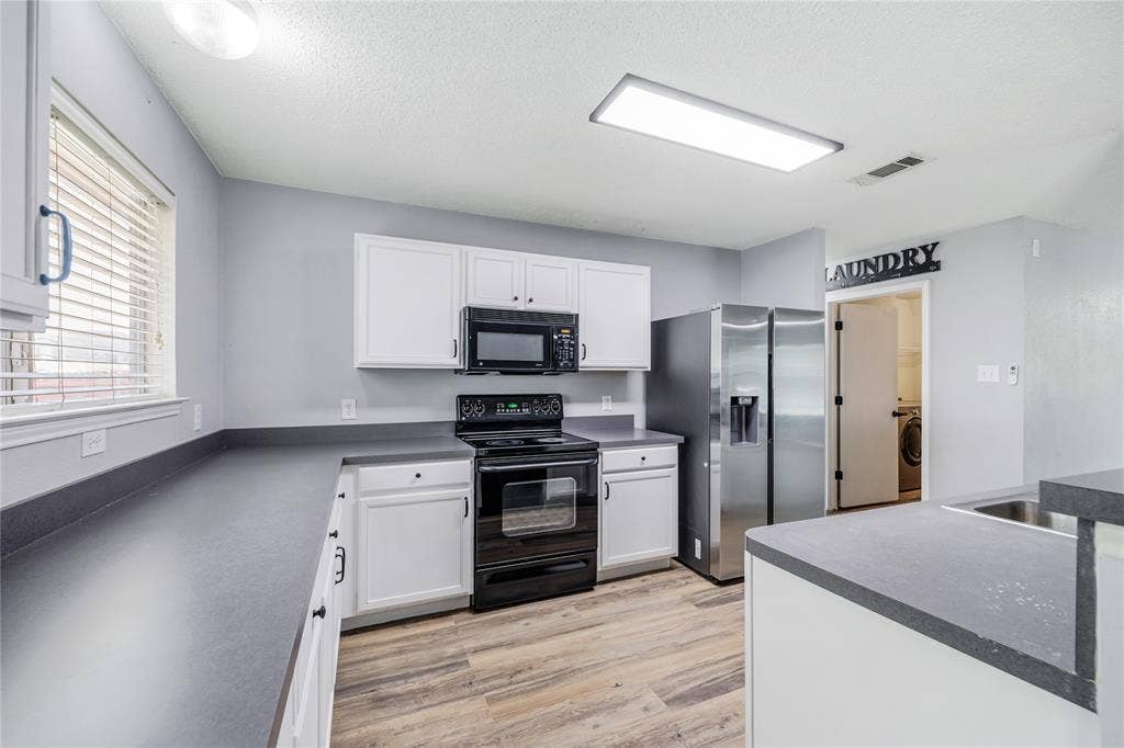 117 Palomino Lane, Krum, TX 76249 Loads of cabinets and counter space in this kitchen.