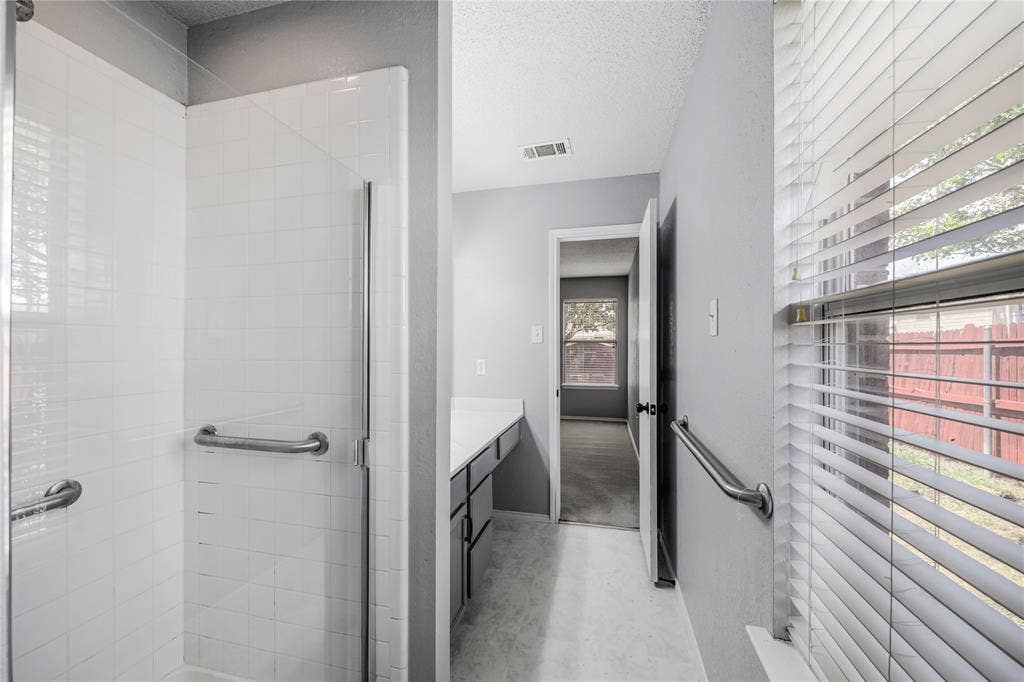 117 Palomino Lane, Krum, TX 76249 Tiled surround separate shower and a window in this ensuite primary suite