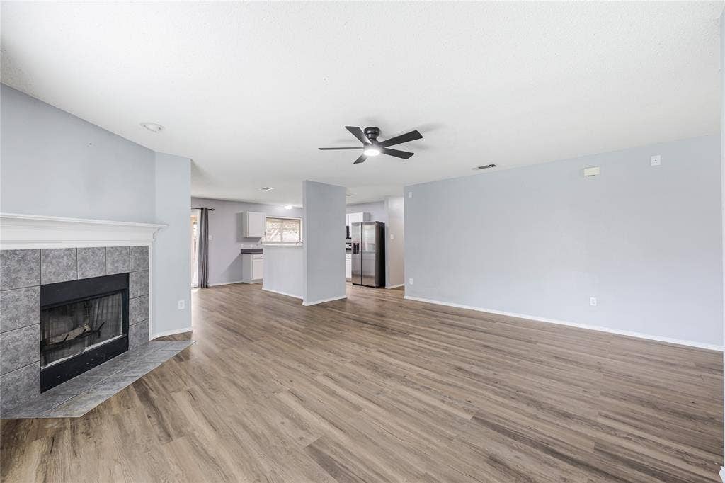 117 Palomino Lane, Krum, TX 76249 A wood burning fireplace and generous wall space in the living room for furniture placement