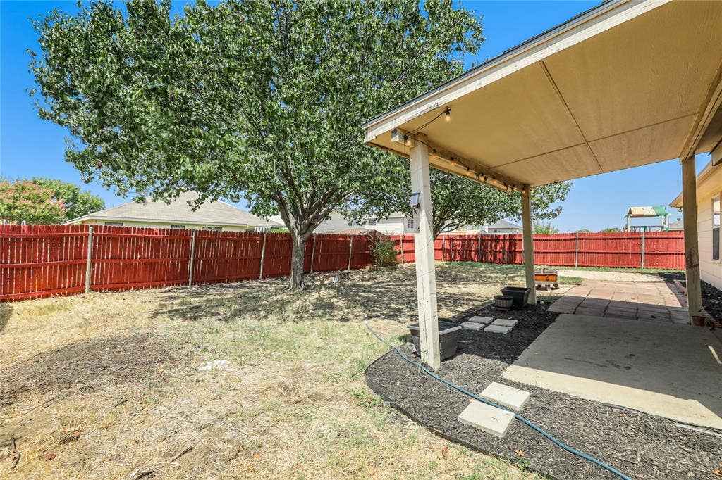 117 Palomino Lane, Krum, TX 76249 Large covered patio and fresh stained wood fence.