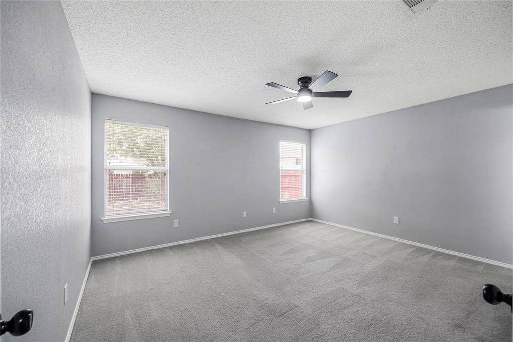 117 Palomino Lane, Krum, TX 76249 This large primary bedroom looks on to the large backyard and features good wall space for furniture placement
