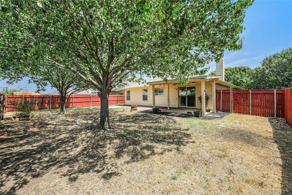 117 Palomino Lane, Krum, TX 76249 Great back yard ready for entertainment or relaxation with the extended covered back patio and beautiful shade trees.