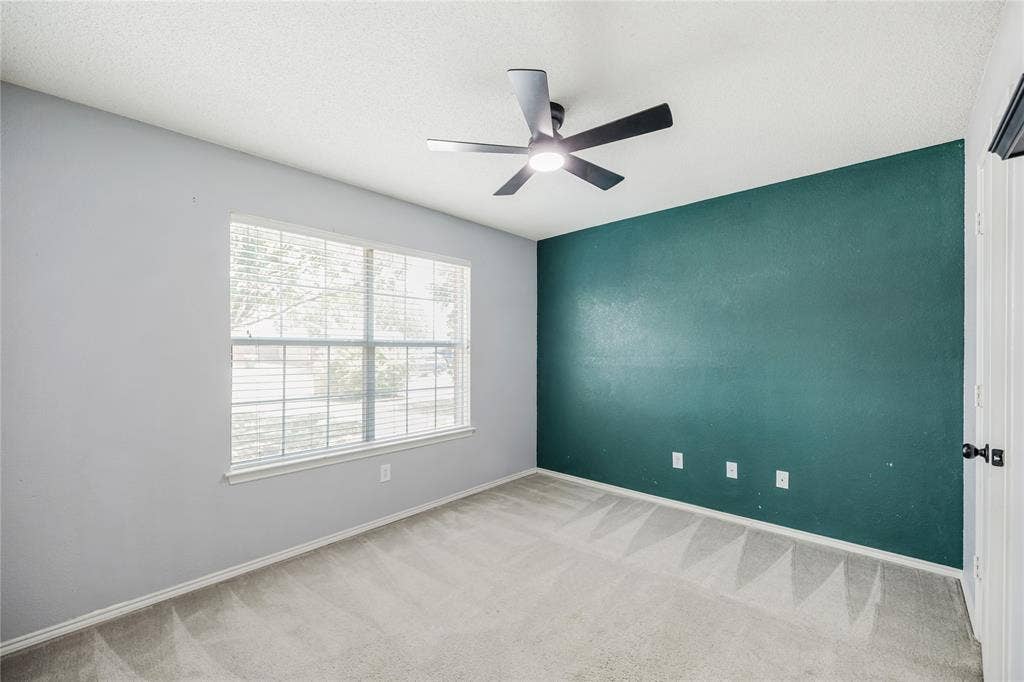 117 Palomino Lane, Krum, TX 76249 Front bedroom with new modern ceiling fan and a large walk-in closet