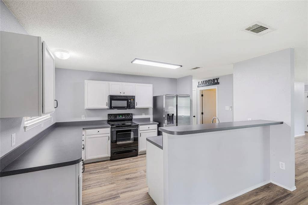 117 Palomino Lane, Krum, TX 76249 This view of the kitchen features the large breakfast bar and generous counter space.
