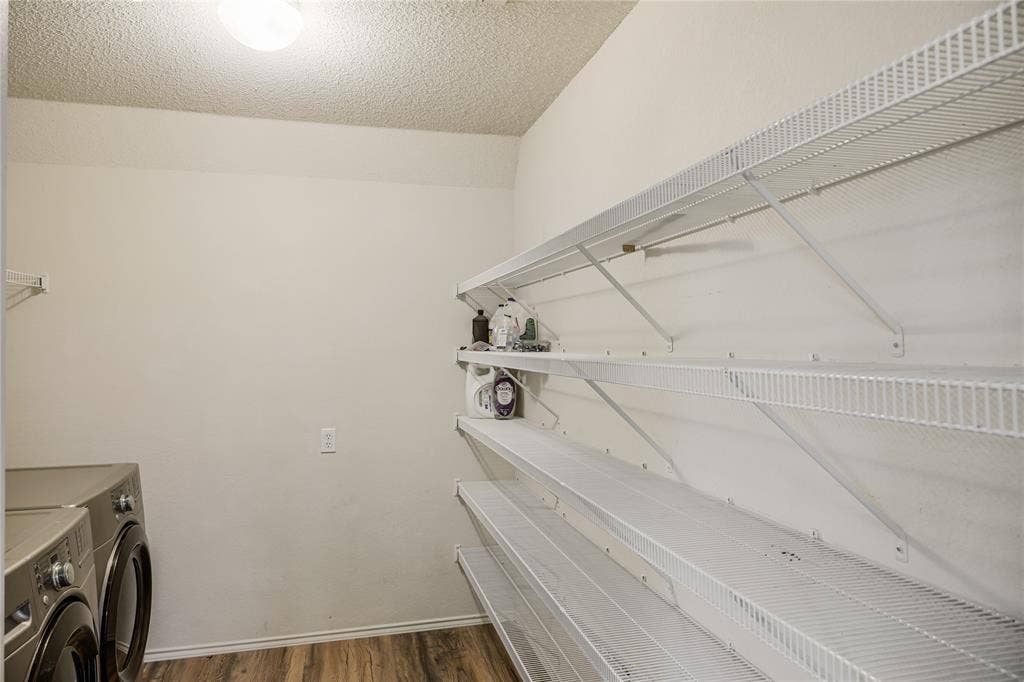 117 Palomino Lane, Krum, TX 76249 The large utility room features a full sized washer and dryer and a generous amount of shelving for pantry and storage.