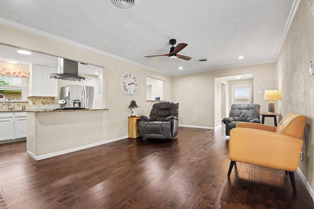 1114 Glouchester Drive, Garland, TX 75040 Wood-finish flooring throughout, stainless steel kitchen appliances, granite countertops, white cabinetry, and a ceiling fan