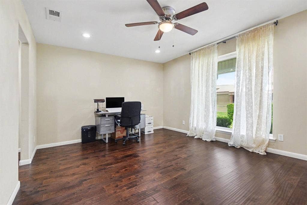 1114 Glouchester Drive, Garland, TX 75040 Wood-finish flooring, recessed lighting, ceiling fan with integrated light, and a large window